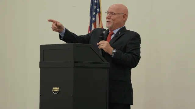 Ken Massey points toward the crowd from the podium at his campaign launch